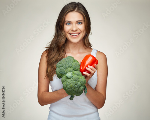 smiling woman holding vegetabless. photo