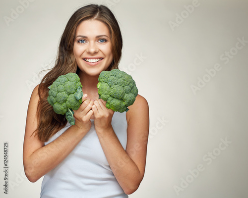 Broccoli is healthy food. Beautiful smiling woman healthy lifest