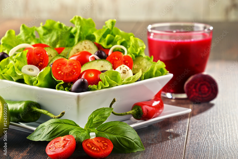 Composition with vegetable salad bowl and glass of juice Composition with vegetable salad bowl and glass of juice