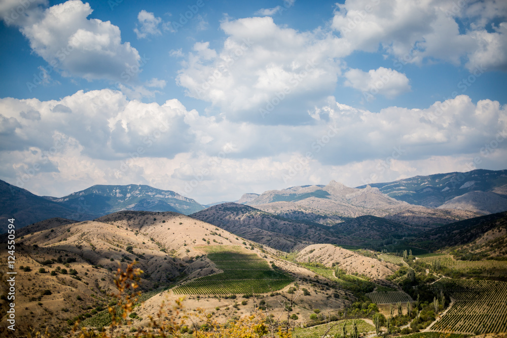 Panoramic scenic views of hilly valley and blue cloudy sky