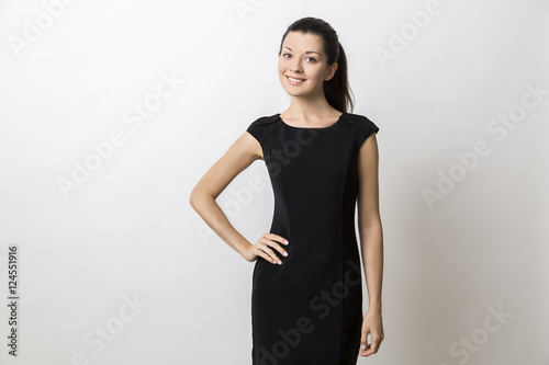 Smiling young woman in long black dress