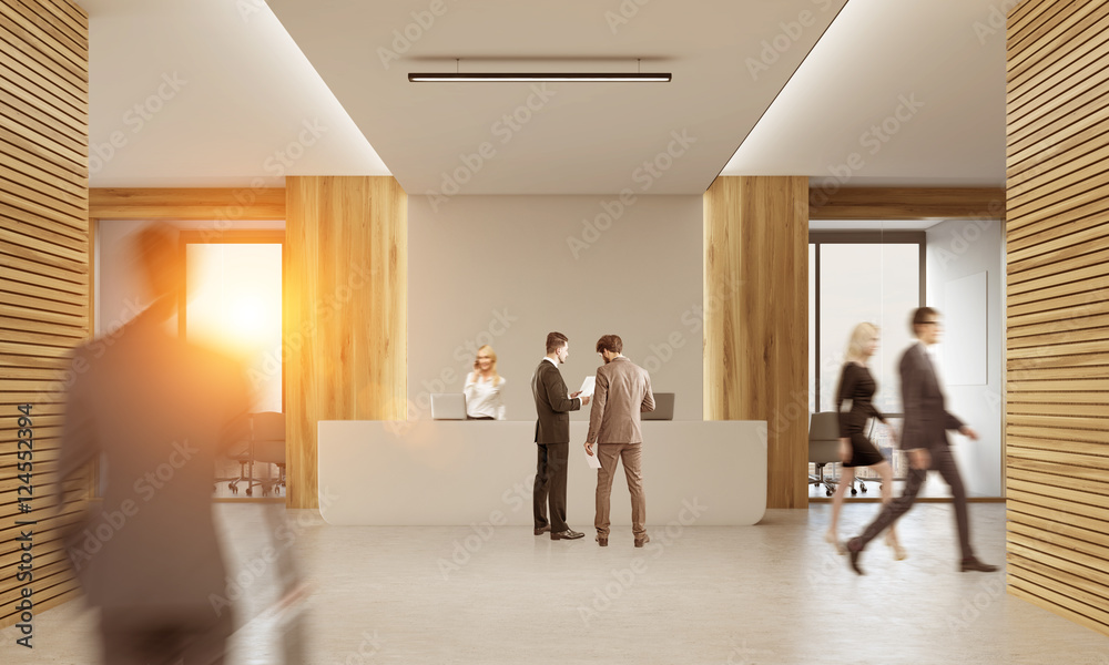 Rear view of business people in office with two receptionists Rear view of business people in office with two receptionists