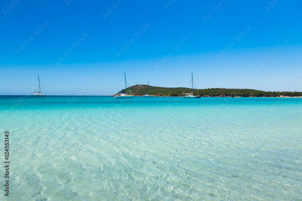 Boats mooring in the turquoise water of Rondinara beach in Cors Boats mooring in the turquoise water of Rondinara beach in Cors