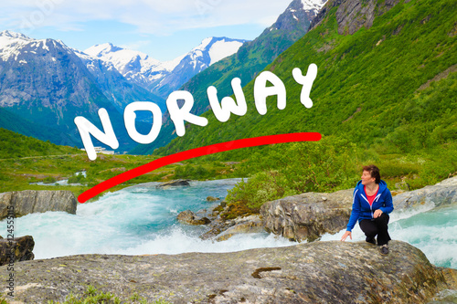 Tourist woman by Videfossen Waterfall in Norway photo