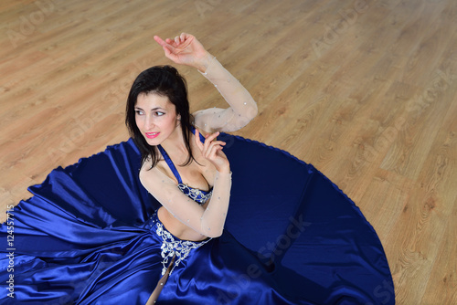 Beautiful woman in arabic costume dancing in motion  oriental or belly dance  shoot from high angle