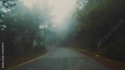 Pov driving on foggy dark scary mountain road at winter