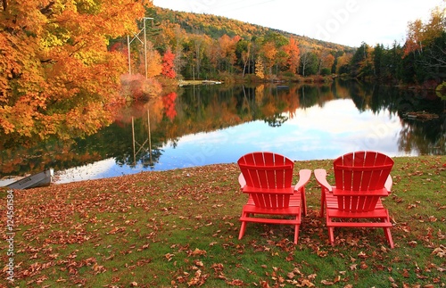 Fall in Vermont. Two red chairs overlooking a lake in Vermont. photo