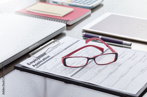 Businessman or job seeker fill in Employment Application form with pen. job vacancy concept.