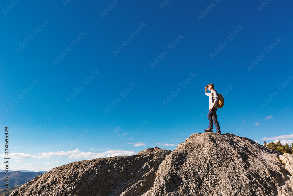 Man walking on the edge of a cliff