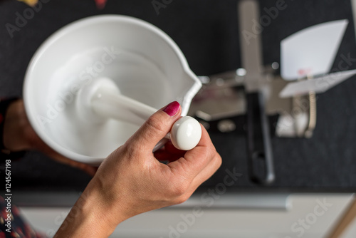 Pharmacist manufactures ointment in a pharmacy photo