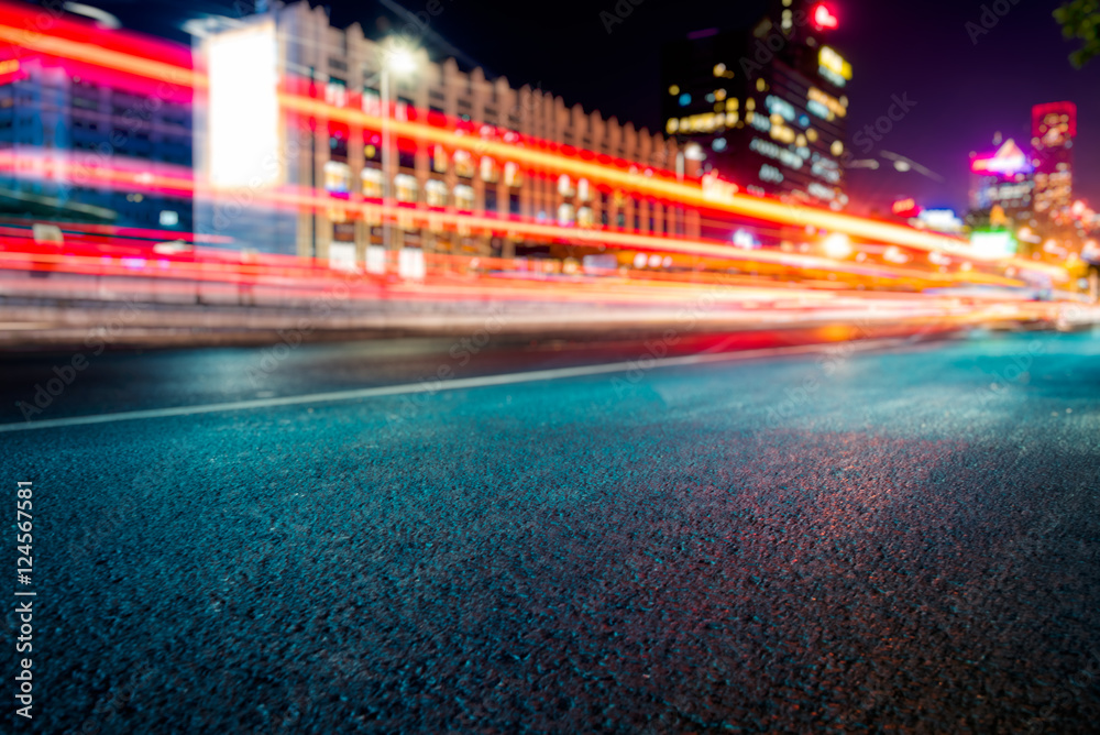 blurred traffic light trails on road at night in China.