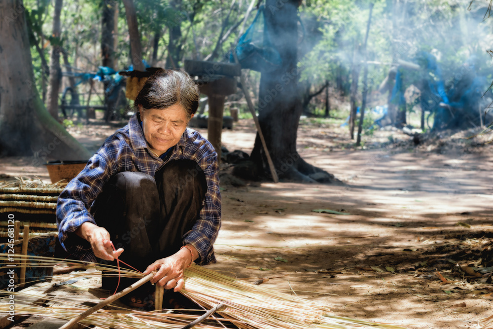 Older women in Asia are using mortars in traditional Asian cooki Older women in Asia are using mortars in traditional Asian cooki