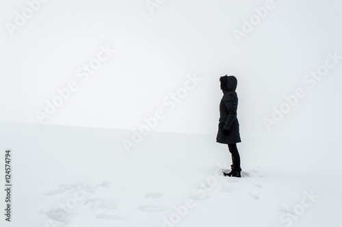 Woman standing in a snowy field