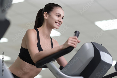 Delighted girl training on a treadmill. © zinkevych