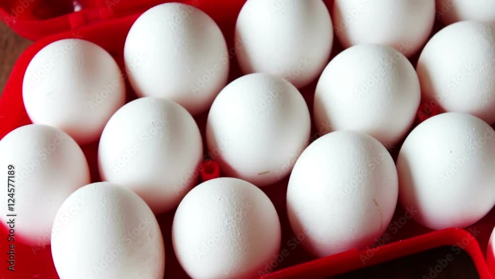 raw eggs in a red plastic tray or box
