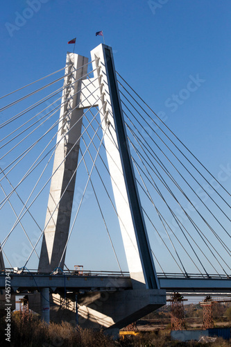Construction of a new overhead bridge over the River with the flags of the European Union