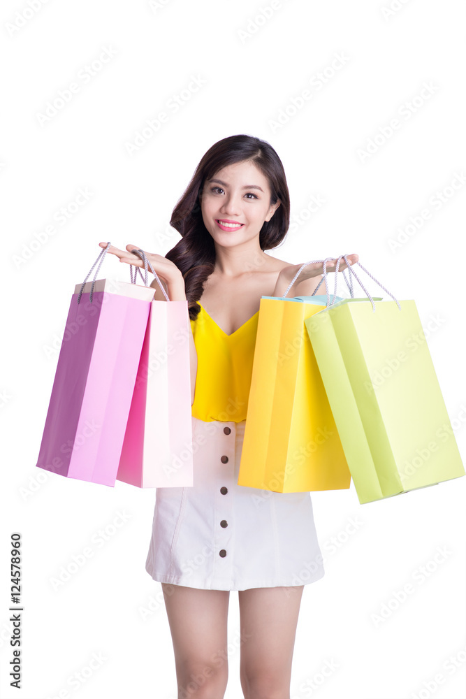 Asian smiling young woman holding colorful paper bags. Concept f