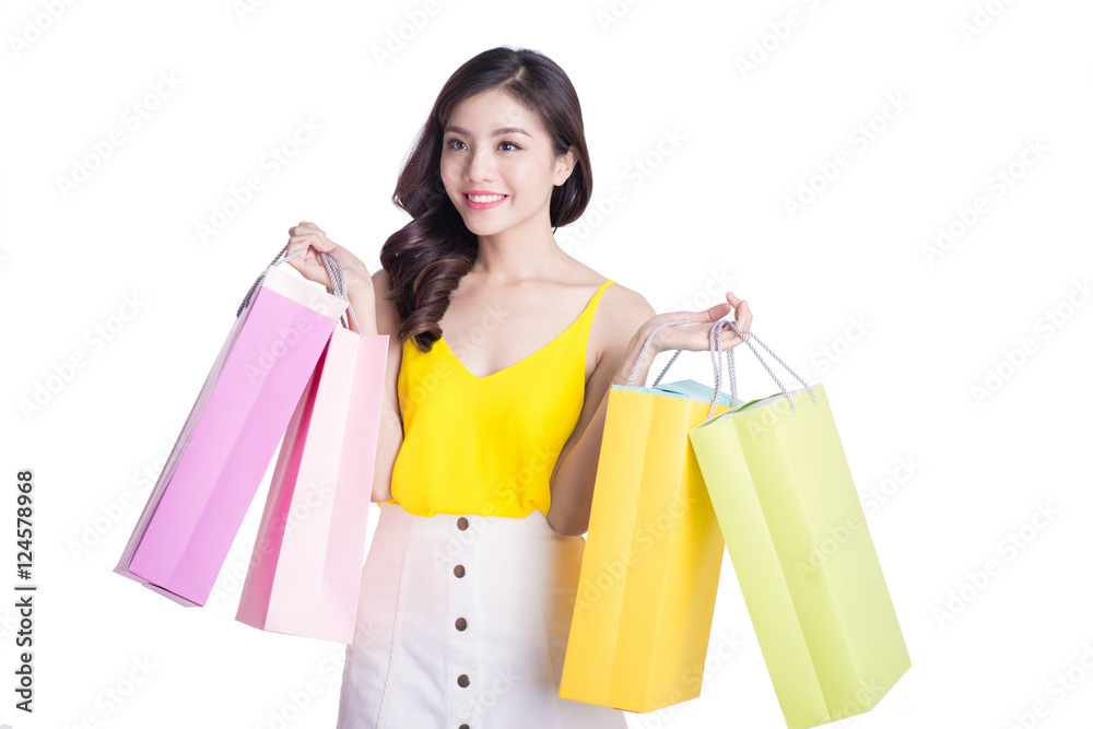 Asian smiling young woman holding colorful paper bags. Concept f Asian smiling young woman holding colorful paper bags. Concept f