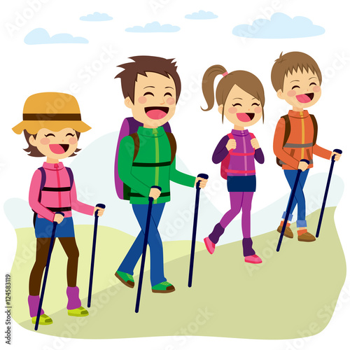 Happy family climbing mountain with sticks on a trip vacation day