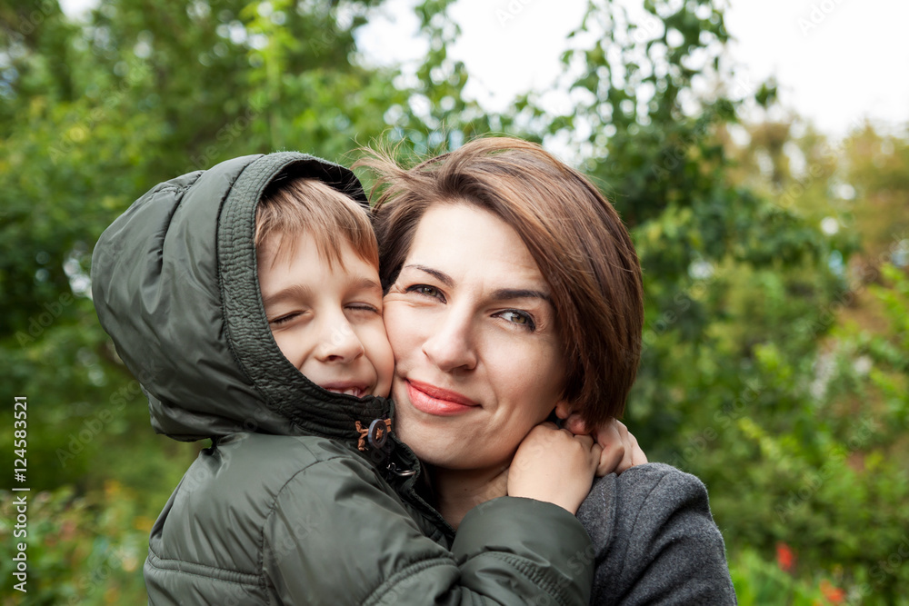 Mother and son hugging in park Mother and son hugging in park