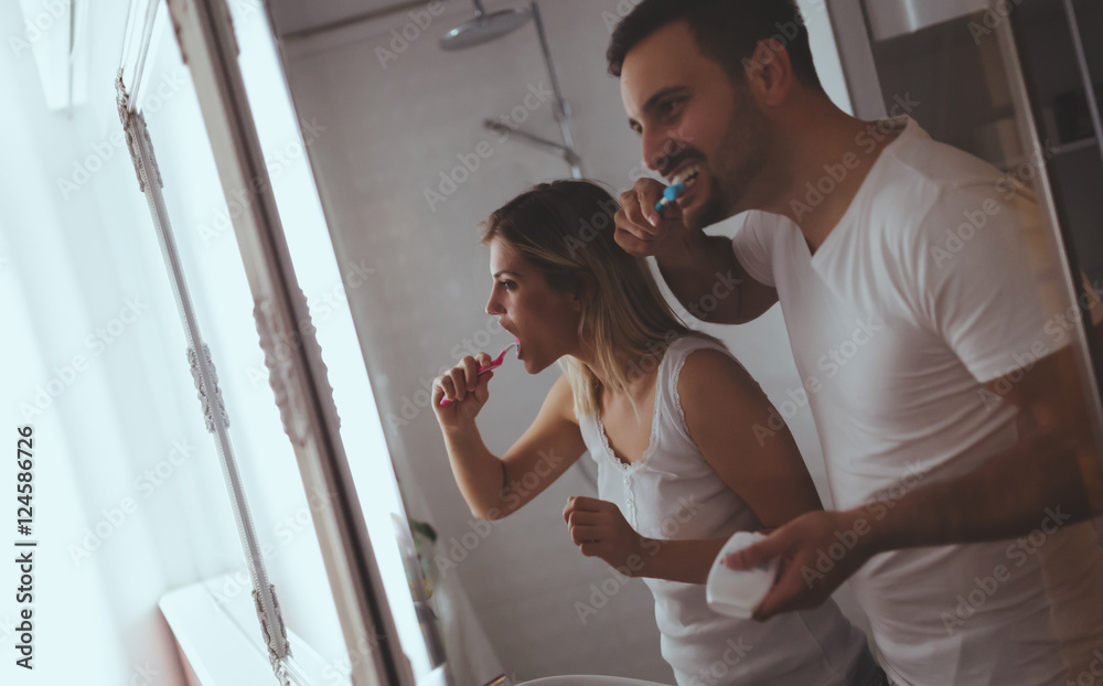 Couple washing teeth in morning Couple washing teeth in morning