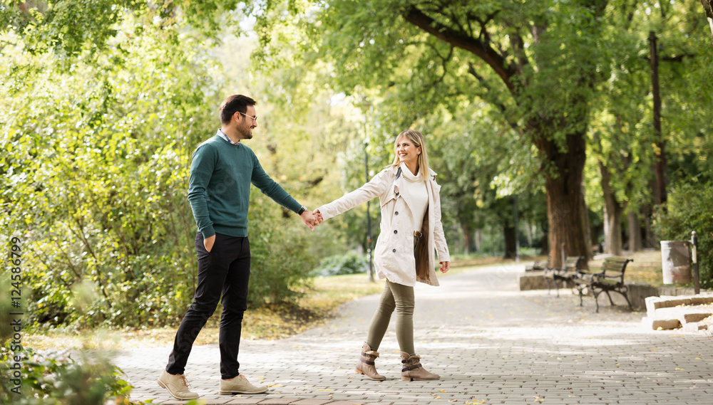 Fototapeta premium Happy couple walking in park