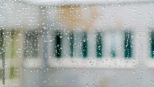 Rain drops on glass window. Blurred background