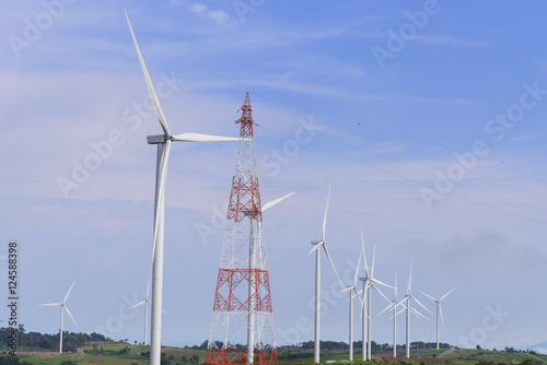 The big windmill turbine field and the electricity pylon with th