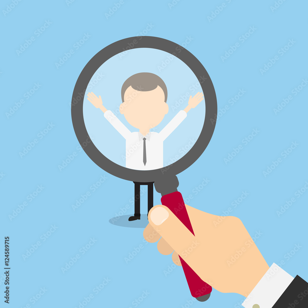 Hiring staff concept. Hand with magnifying glass finding and recruiting new worker.