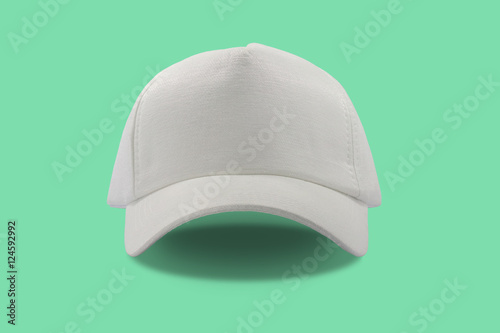 Closeup of the fashion white cap isolated on green background.