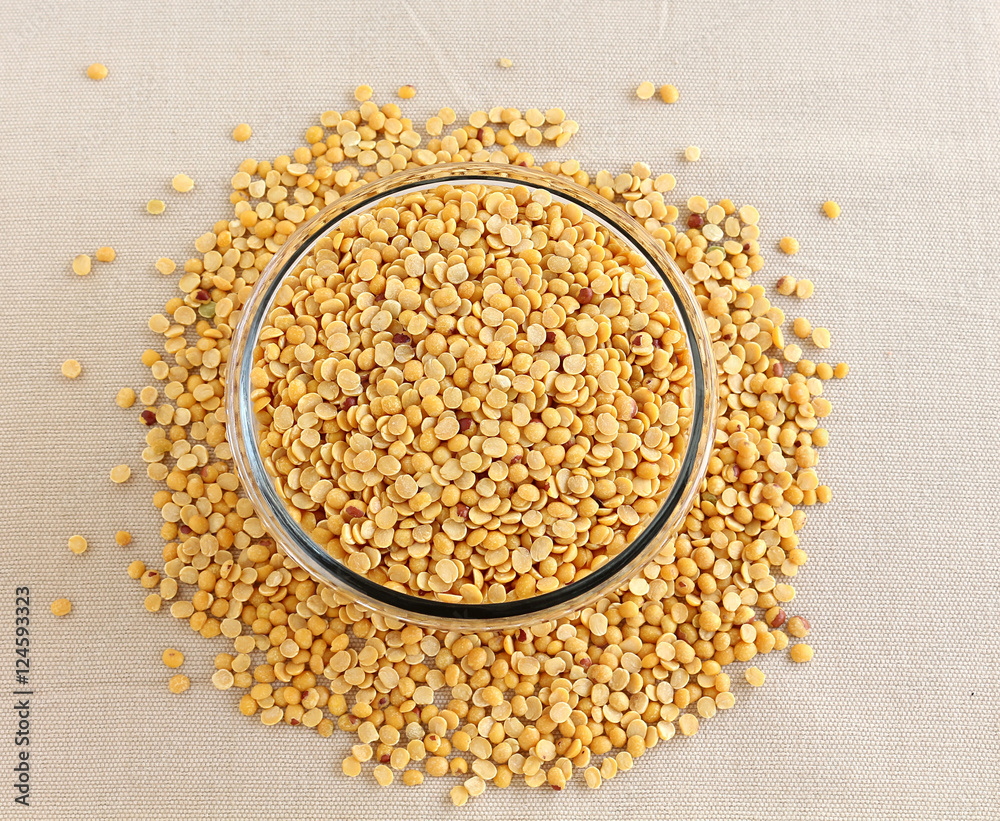 Toor dal, also known as split pigeon pea, rich in proteins, in a glass bowl. Toor dal, also known as split pigeon pea, rich in proteins, in a glass bowl.