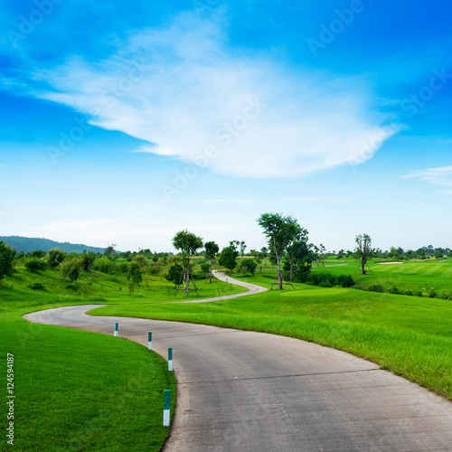 concrete walk way in golf link and blue sky