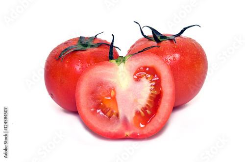 Tomato fruit with half cross section isolated on white backgroun photo