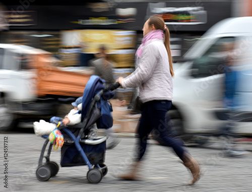 Mother with small child in the stroller