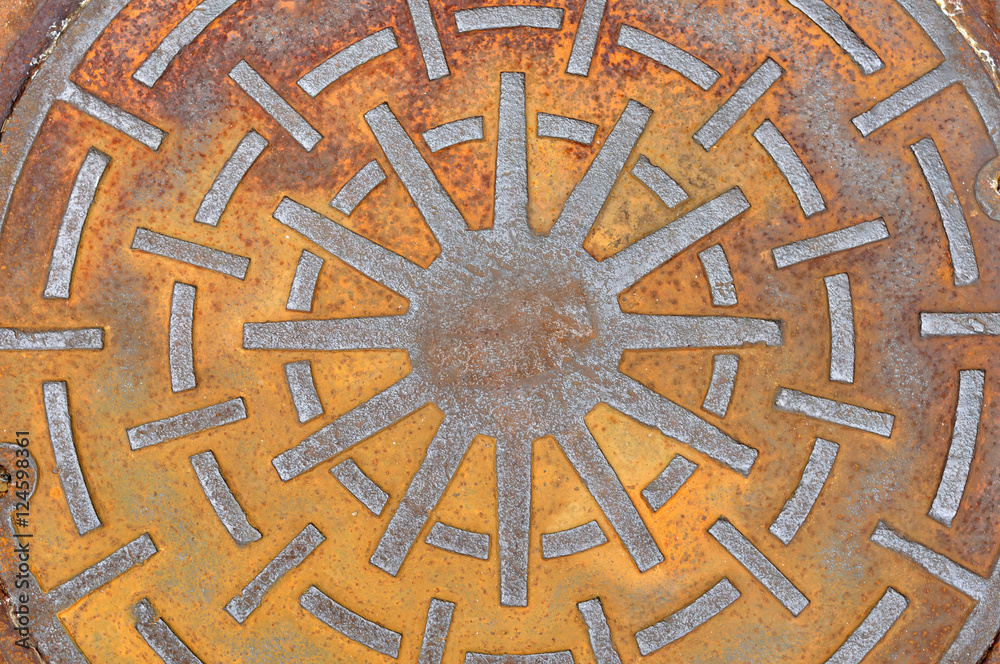 Rusty manhole cover on street, drain cover top view.