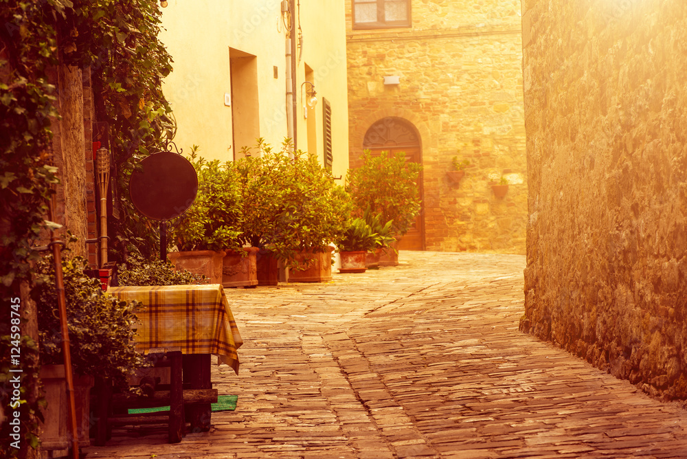 Empty street of small Tuscany town San Quirico d'Orcia with sun shine, romantic travel vintage hipster european italy background