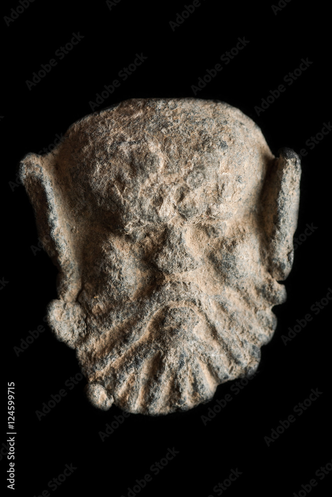 Ancient post seal in the shape of head isolated on black Ancient post seal in the shape of head isolated on black