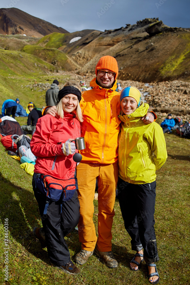 Couple of friends tourists traveling on vacation, hiking in Iceland. smiling friends hugging and posing