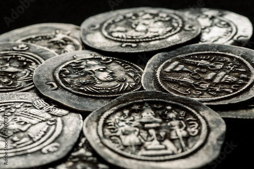 Silver coins af ancient Persia on a black background