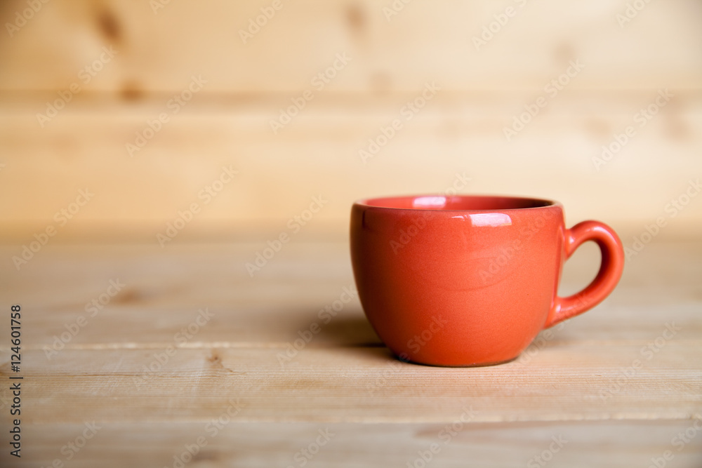 Red coffee cup on wooden table Red coffee cup on wooden table