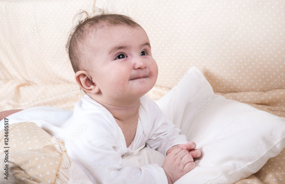 Child playing in a bed and does not want to sleep Child playing in a bed and does not want to sleep