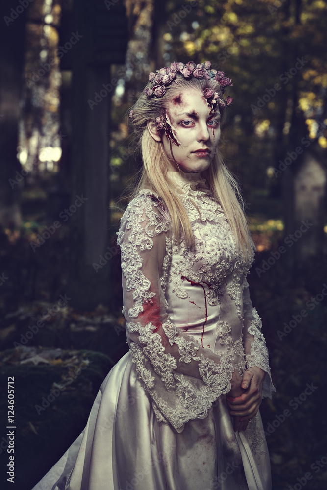 Dressed in wedding clothes romantic zombie woman.