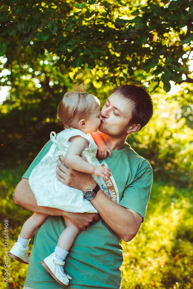 young father kissing his stunning little baby young father kissing his stunning little baby