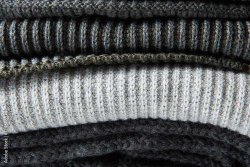 Stack of gray woolen knitted sweaters photo