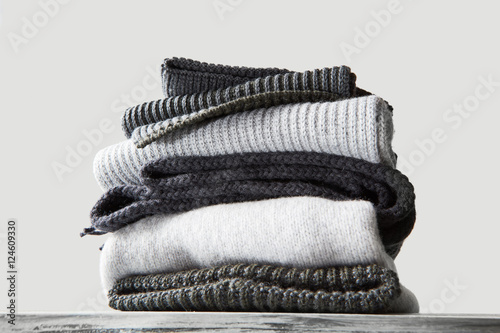 stack of warm winter knitted sweaters photo