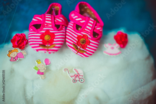 little pink slippers lying on a bed photo