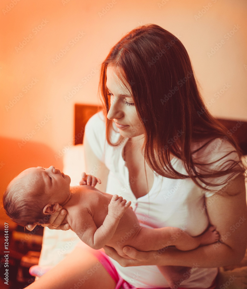 a young mother holds her newborn amazing baby a young mother holds her newborn amazing baby