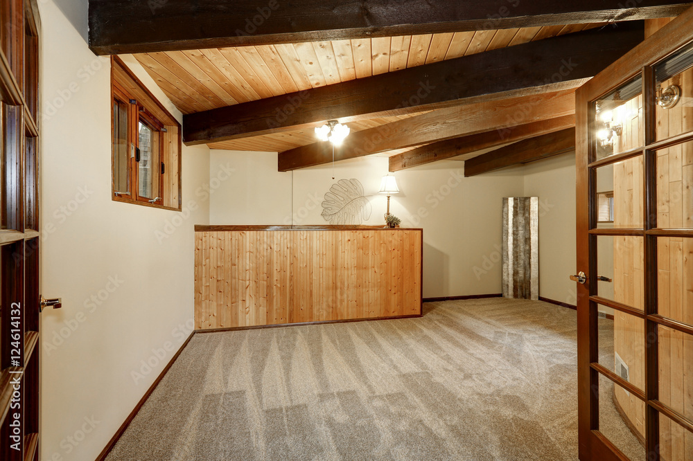 Wooden house interior with carpet floor , ceiling with wooden beams