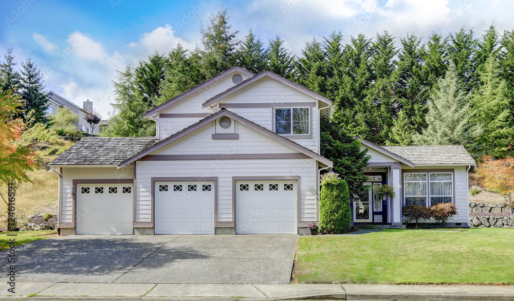 Luxury house exterior with three garage spaces Luxury house exterior with three garage spaces