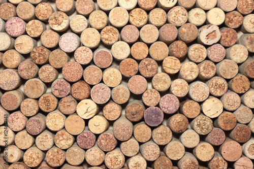 many different used wine corks in the background